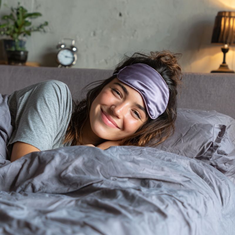 Happy morning scene of a girl waking up naturally after using sleep-enhancing products from Restora Dream