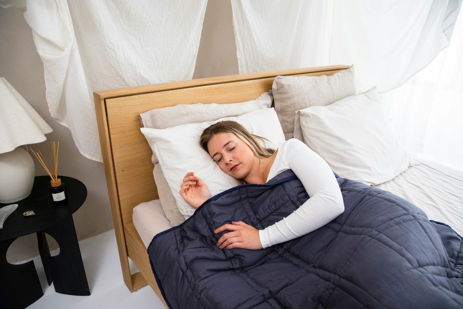A girl sleeping on grounded fitted bed sheets