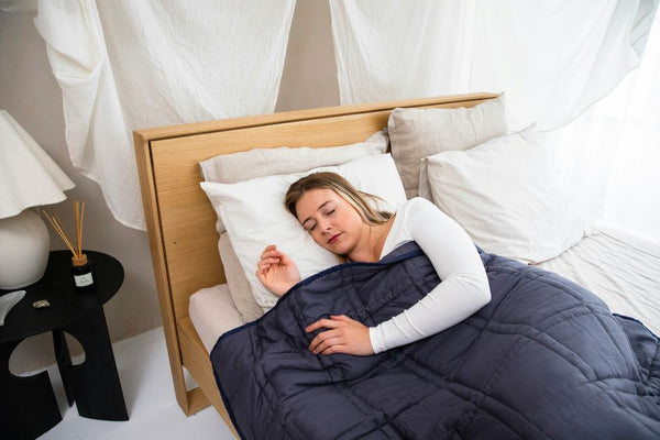 A girl sleeping on grounded fitted bed sheets