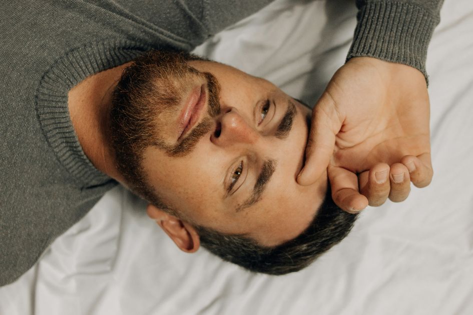 Man lying down considering nasal breathing benefits with Restora Dream mouth tape
