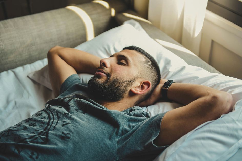 a man sleeping soundly after using a white noise sleep machine
