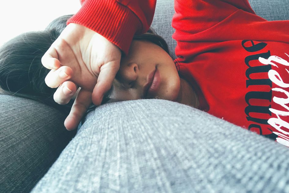 a teen sleeping on the sofa