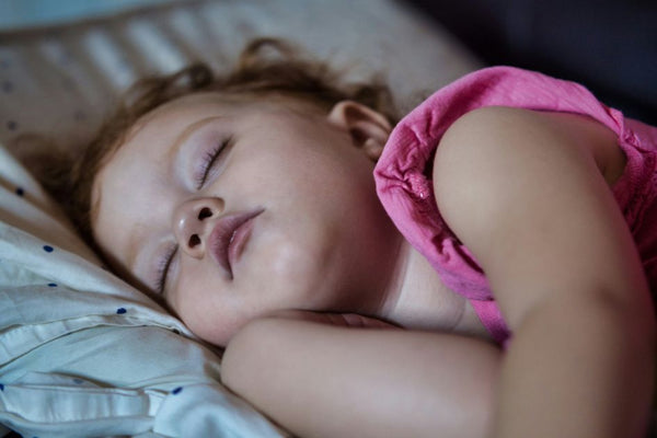 a toddler sleeping soundly after listening to the DreamWhisper