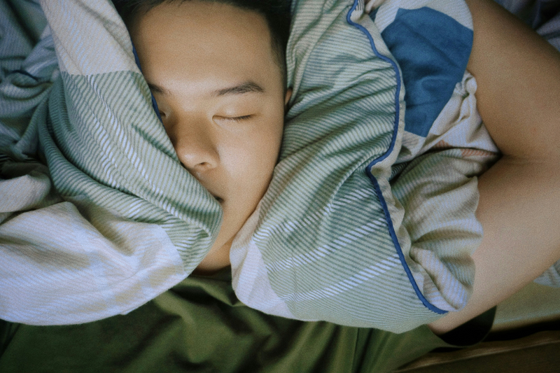 A sleeping peacefully knowing he is wearing the COLMI R03 Smart Ring
