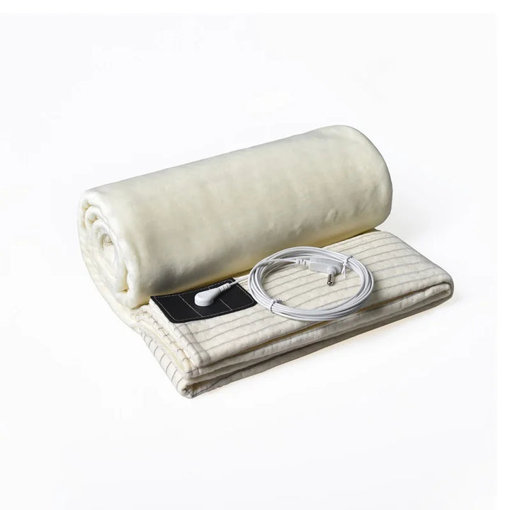 Rolled-up beige-colored grounding blanket with silver fiber and grounding accessories