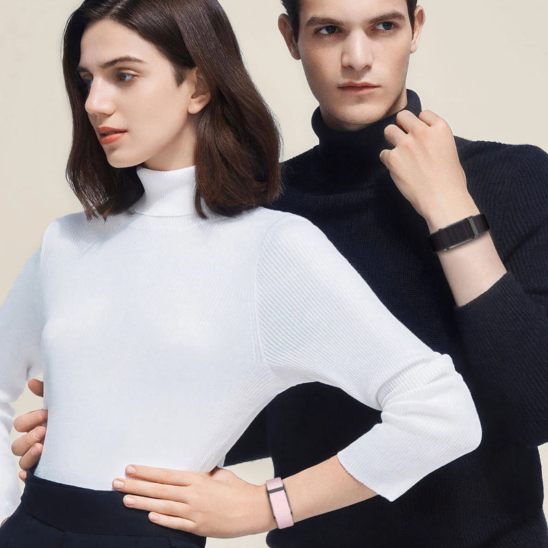 Couple people wearing turtleneck sweaters and their Smart Sleep Band from Restora Dream