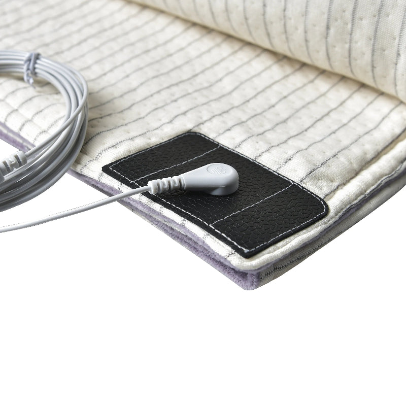 Detailed view of grounding blanket’s silver fiber technology and connection cord