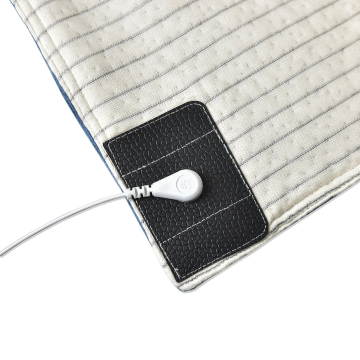 Detailed look at how the grounding cord attaches to the blanket for earthing