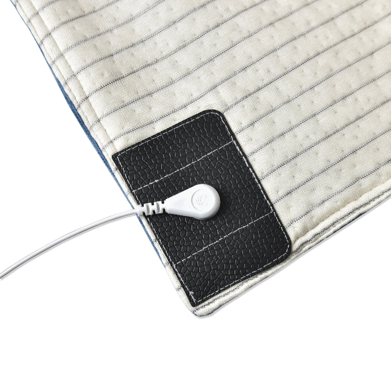 Detailed look at how the grounding cord attaches to the blanket for earthing