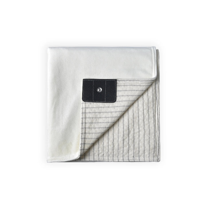 Grounding blanket with a soft white top layer and conductive silver fiber underside