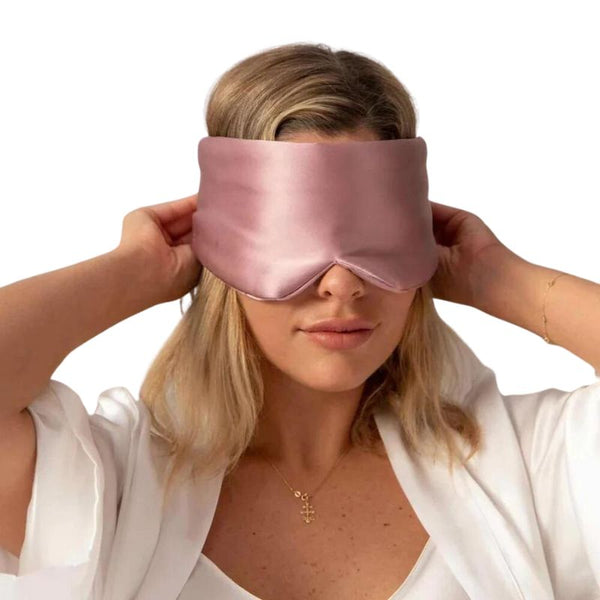 Woman wearing rose luxurious and dreamy silk sleep mask - Restora Dream